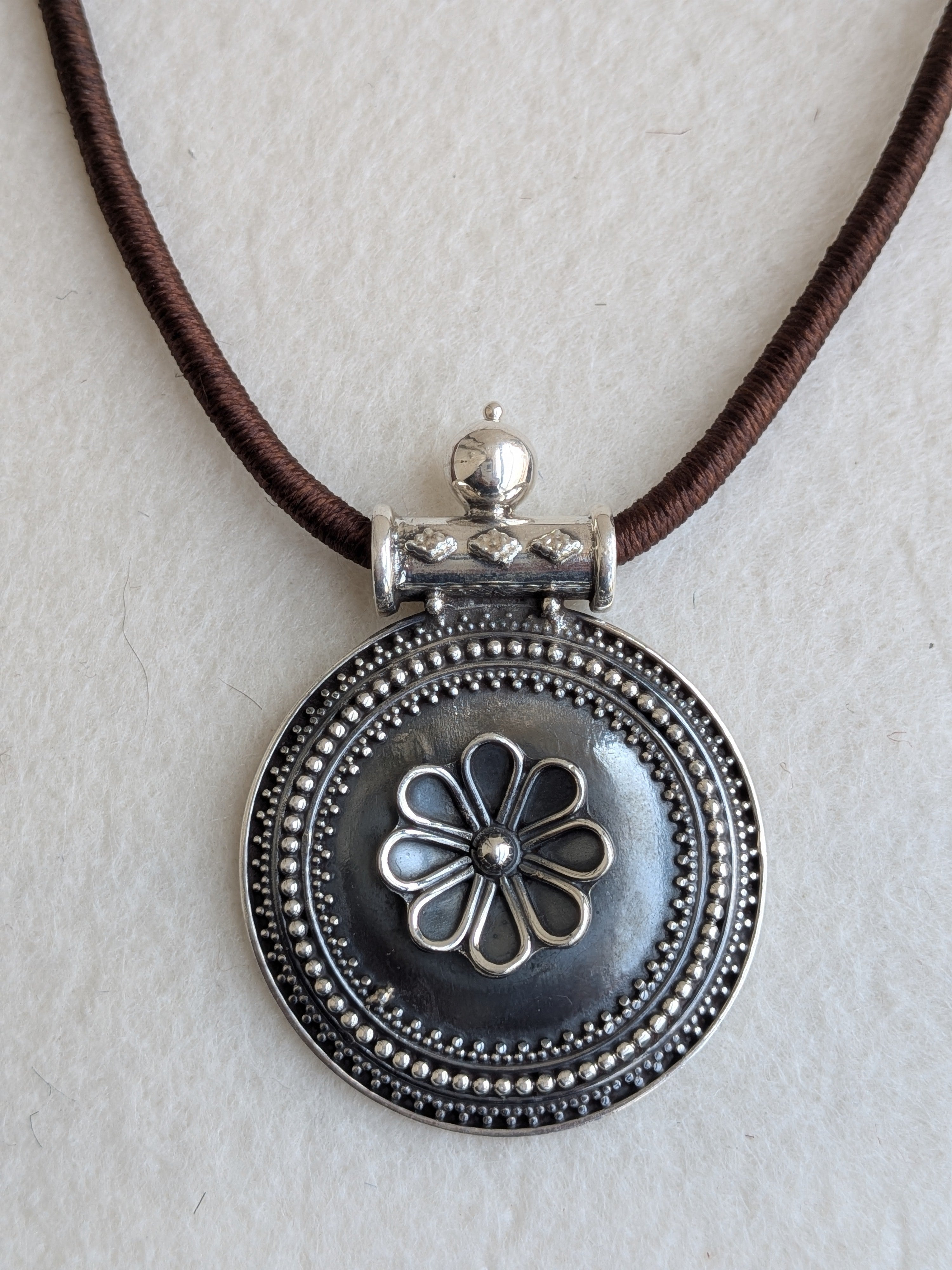Dhara - Statement piece with round 925 Silver pendant and brown dori