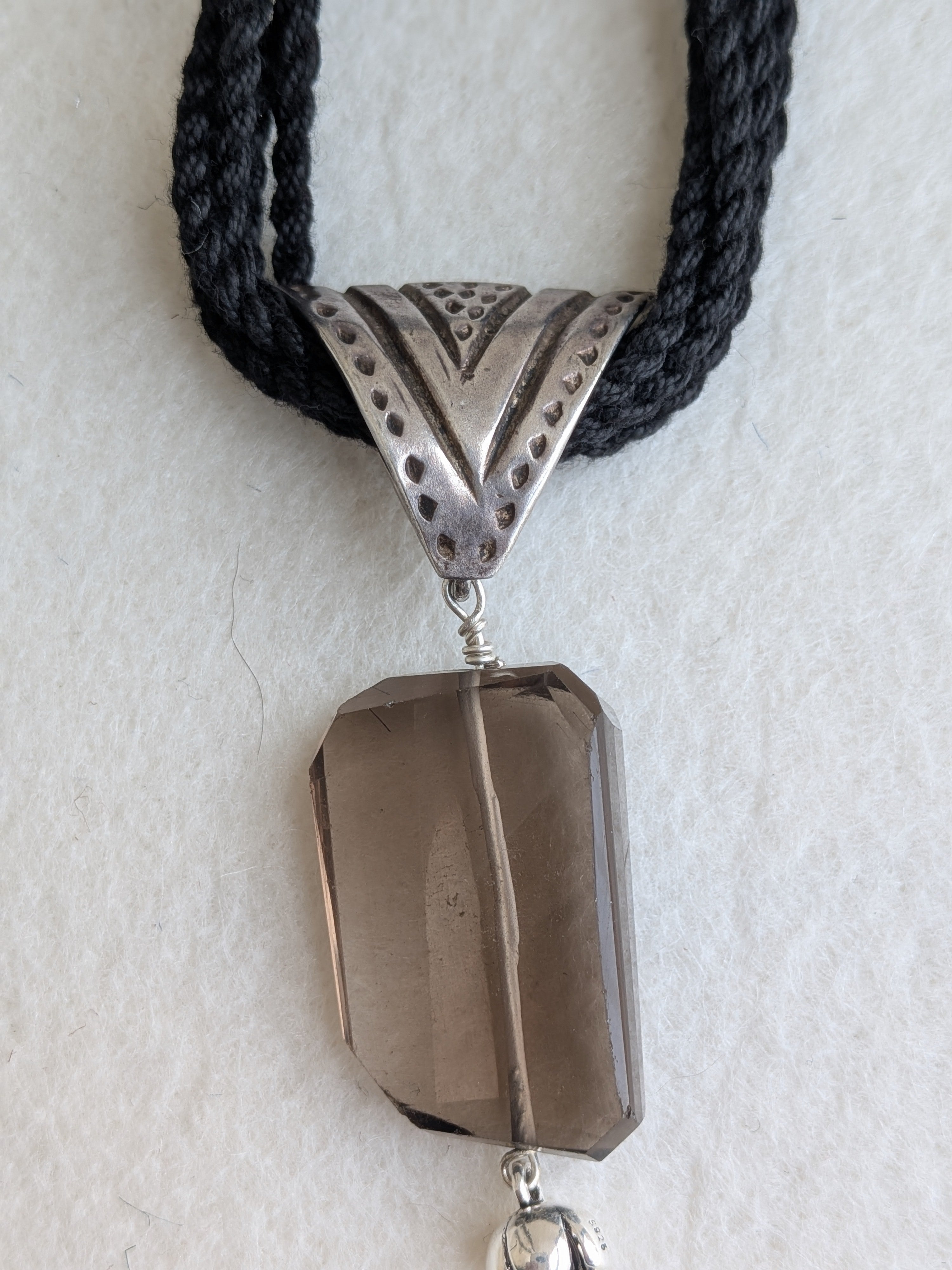 Handcrafted 925 silver triangle pendant adorned with smokey quartz. Perfect for weddings and festivals