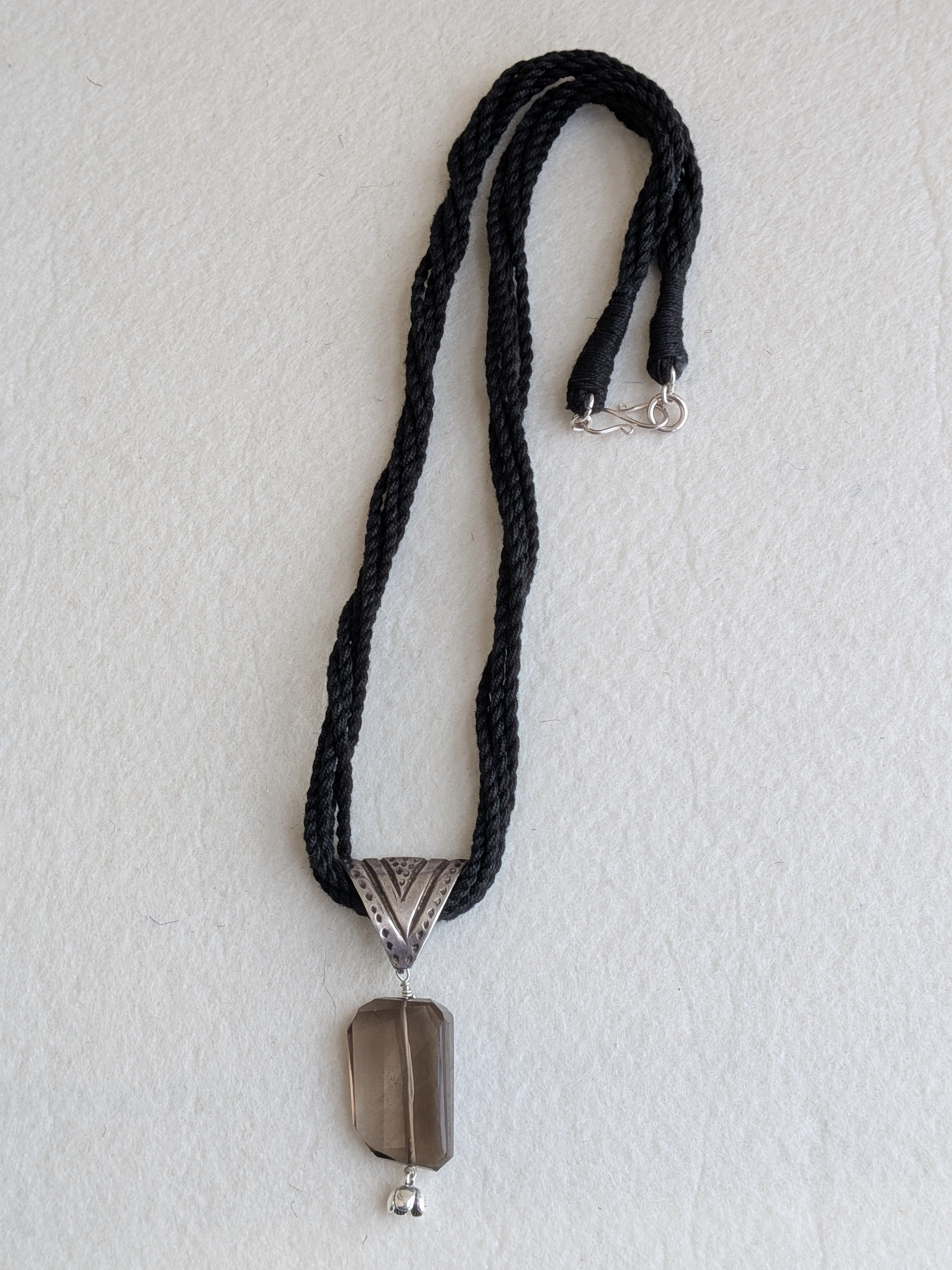 Handcrafted 925 silver triangle pendant adorned with smokey quartz. Perfect for weddings and festivals