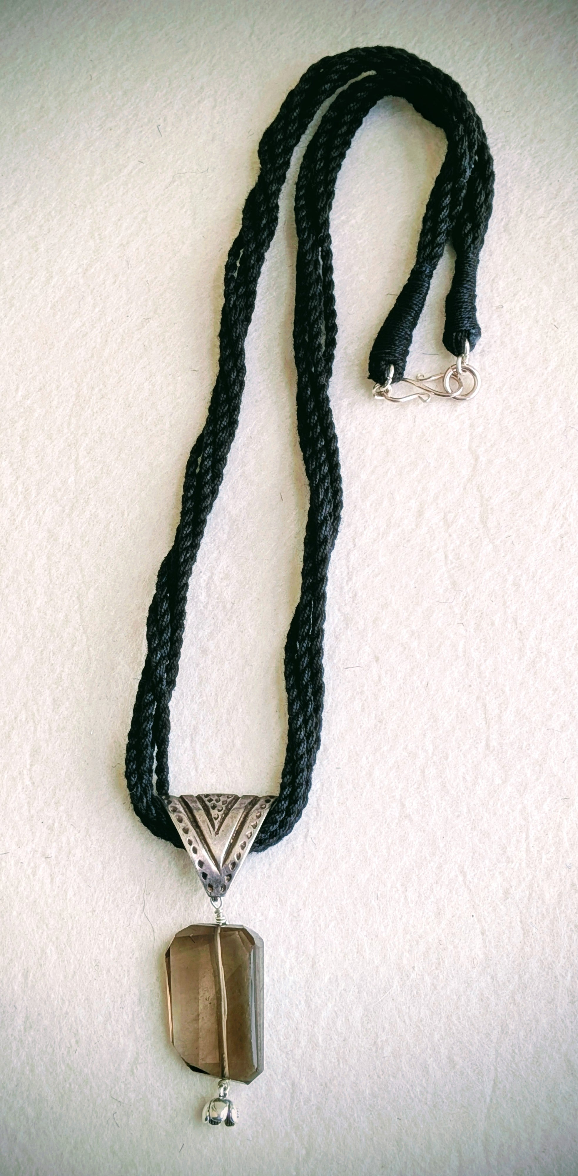 Handcrafted 925 silver triangle pendant adorned with smokey quartz. Perfect for weddings and festivals